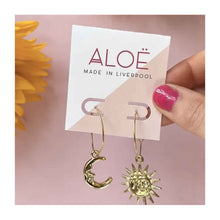  Gold plated hoop earrings from ALOE jewellery. One earring is a crescent moon with face and the other is a full sun with rays and face.