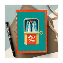  A bold, delightfully illustrated love or friendship card by The Typecast Gallery. It features a pair of sardines in a cute tin with the words "Let's Get Cosy" on the label. 