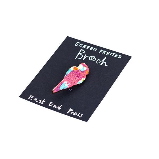 A screen printed brooch, handcrafted by East End Press.