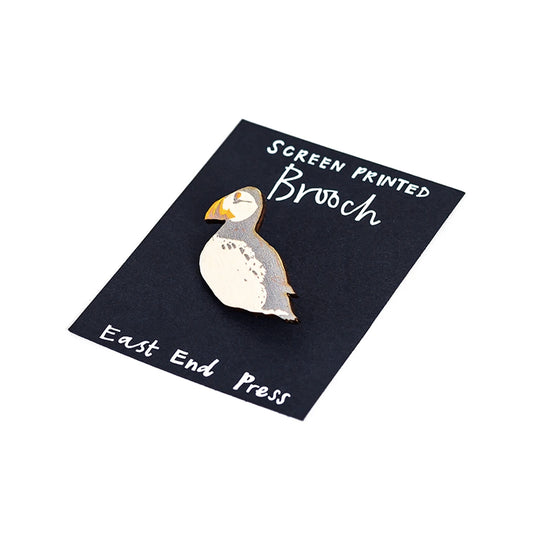 A screen printed brooch, handcrafted by East End Press.