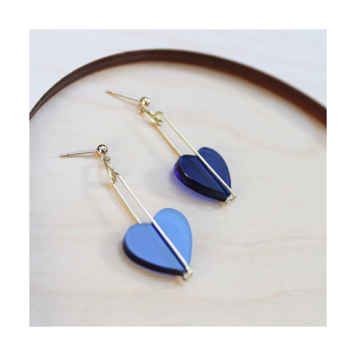 A pair of earrings made from blue perspex and silver. 