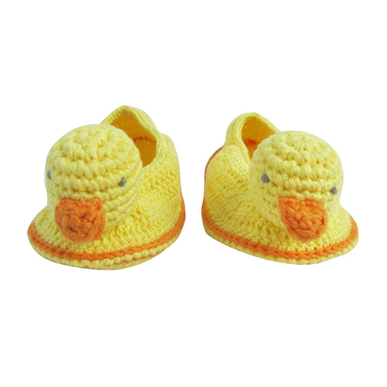 Handcrafted crocheted baby booties in the shape of chicks. Charly Chick booties are bright yellow with orange trims and orange beaks.