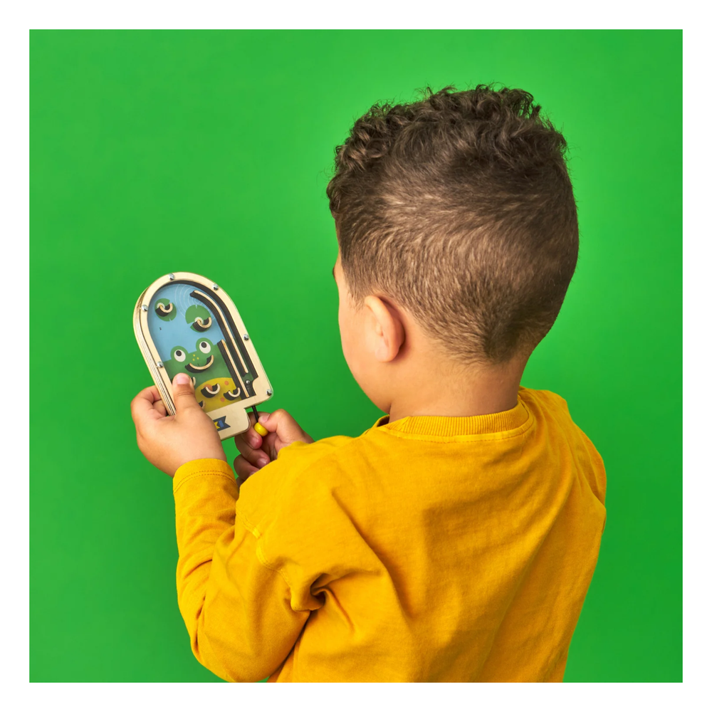 
                  
                    Child holding a colorful toy against a green background
                  
                