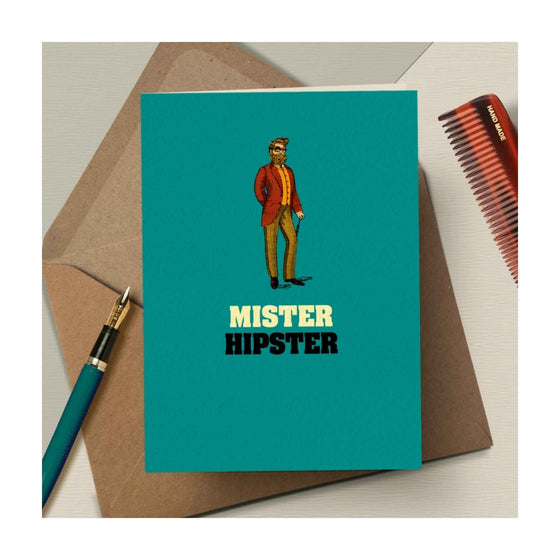 A bold, quirky illustrated card by The Typecast Gallery. It features a vintage-style illustration of a man with a cane, snazzy glasses and a fabulous beard, above the words "Mister Hipster". For the hipster in your life.&nbsp;