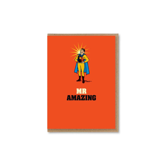 A bold, quirky illustrated card by The Typecast Gallery. It features a vintage-style illustration of a man in a splendid superhero costume, above the words "Mr Amazing". For the superhero in your life.&nbsp;