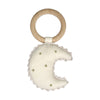 A handcrafted baby rattle made from 100% cotton and a wooden ring. The rattle is in the shape of a crescent moon in cream fabric with gold detailing.