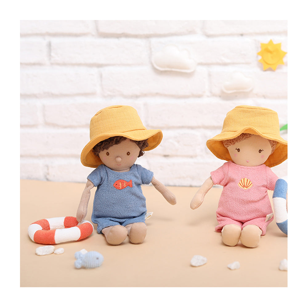 
                  
                    A little baby boy cotton doll set. This doll wears a blue romper with an embroidered fish on his chest. He also wears a yellow sunhat and is holding a rubber ring. Ready for swimming!
                  
                