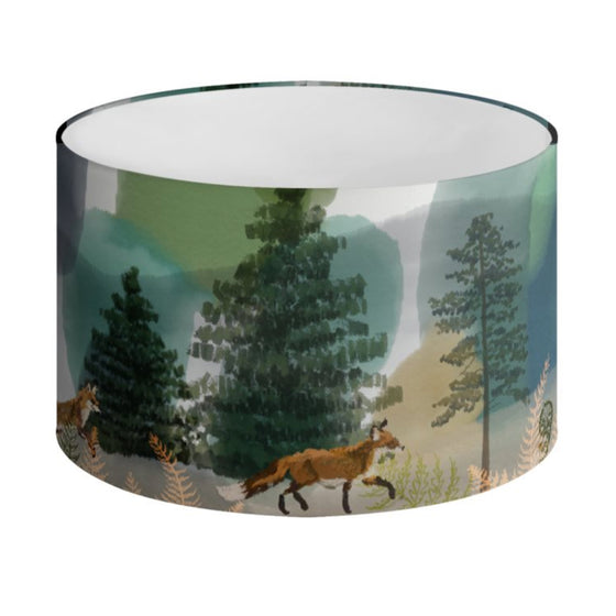 An illustrated lampshade featuring a woodland scene with foxes by Tori Gray / Harbour Lane Studio.