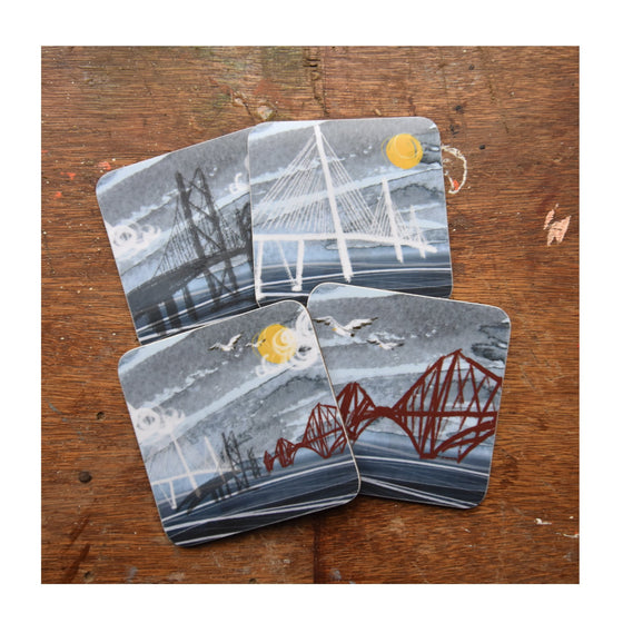 Set of 4 cork backed, melamine coasters featuring 4 different illustrations of the 3 Forth Bridges by Tori Gray. 